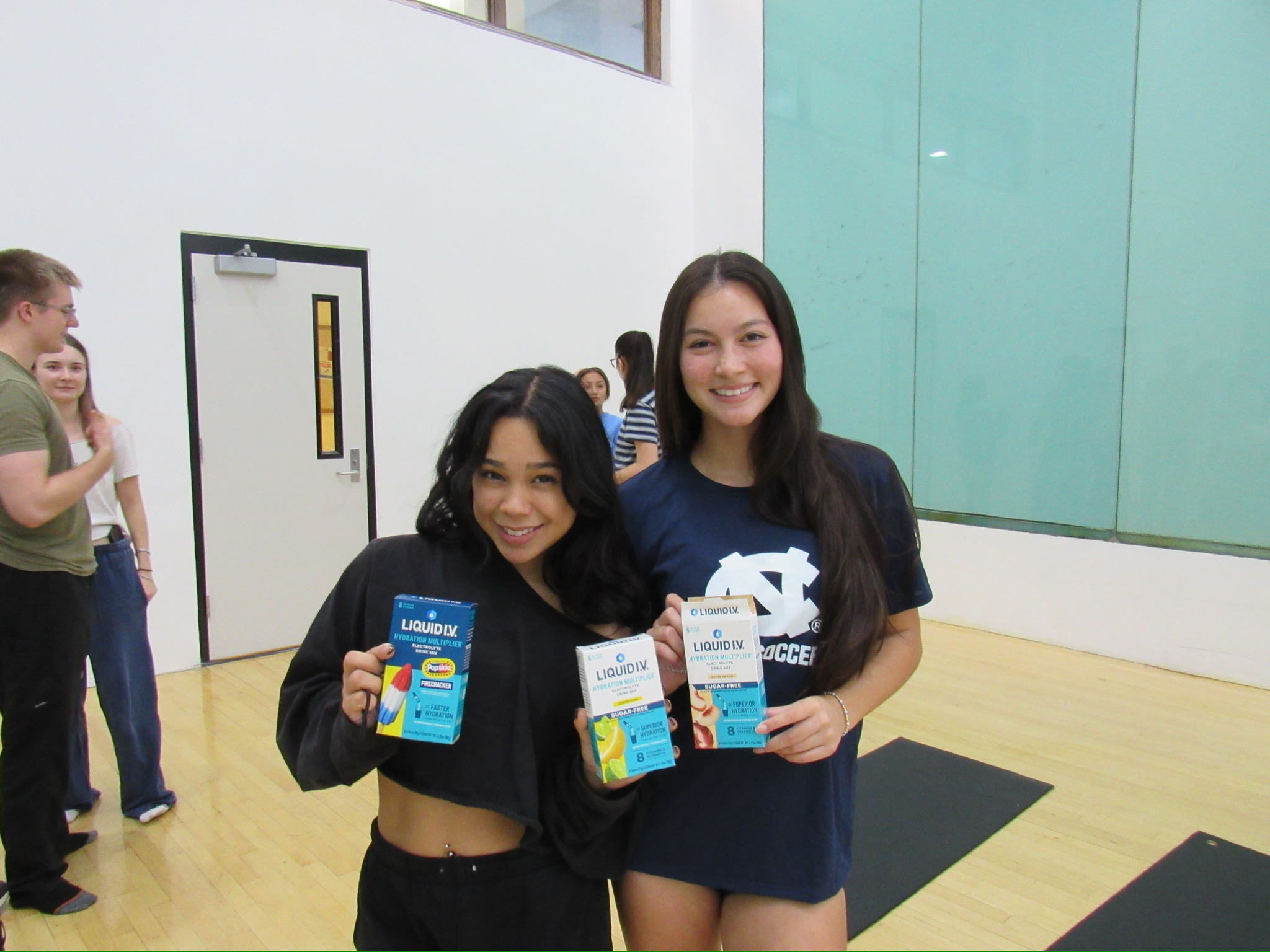 Rebecca and Eleanor posing with Liquid.IV after a meeting