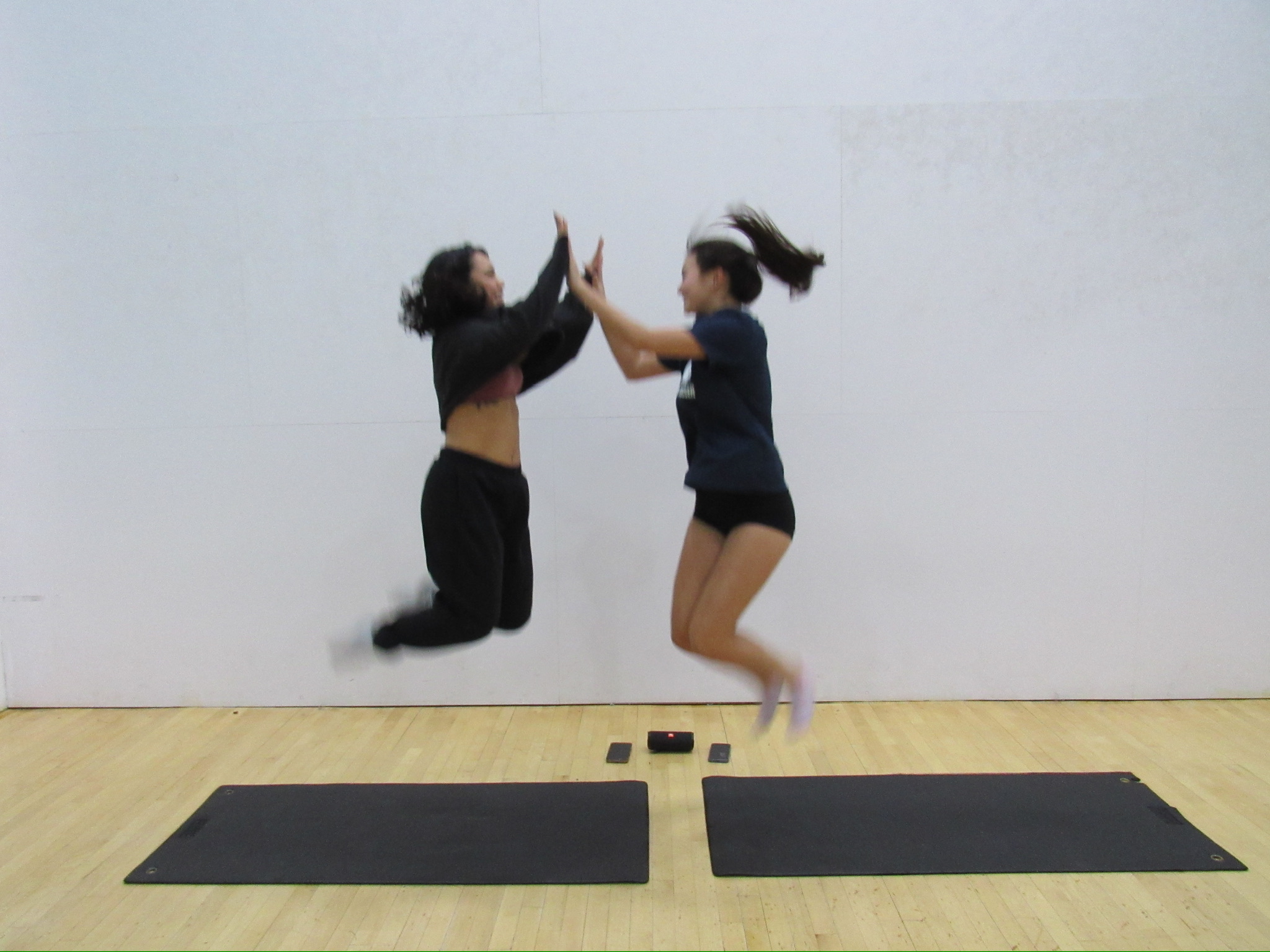 Rebecca and Eleanor jumping and high fiving