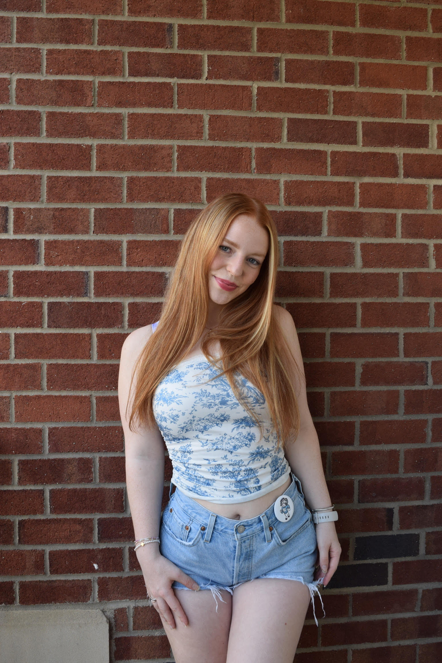 Sarah in front of a brick wall